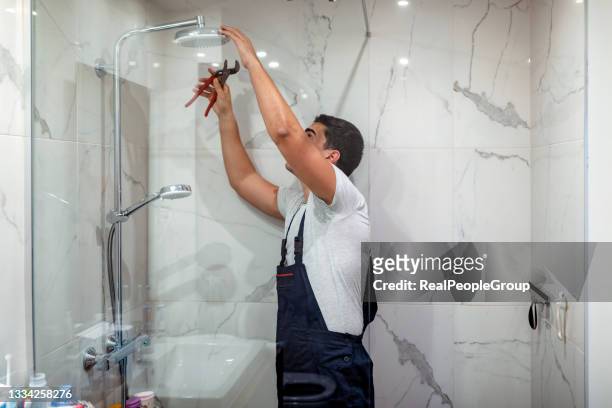 plumber repairing a tap in the bathroom - bathroom bildbanksfoton och bilder