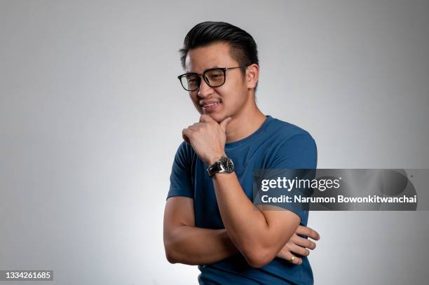 the authentic studio shot of the businessman's relaxing with the casual clothing. - asian man studio shot stock pictures, royalty-free photos & images