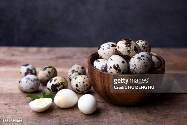 boiled quail eggs on wooded table - quail bird stock pictures, royalty-free photos & images