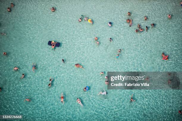 The sea of Fontane Bianche crowded by bathers in an aerial view from the helicopter of the Coast Guard on the day of Ferragosto, within the operation...