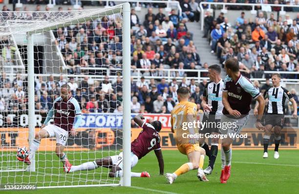Freddie Woodman of Newcastle United fails to save a shot leading to the first goal of West Ham United during the Premier League match between...