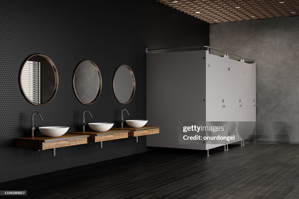 Side View Of Luxurious Public Restroom With Toilets, Mirrors And White Sinks