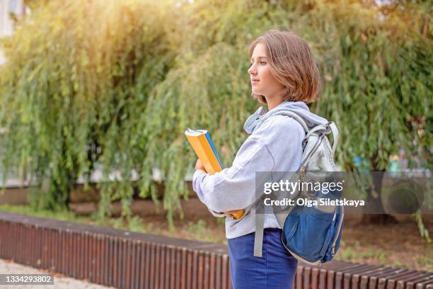 teenage schoolgirl with a backpack and folders. - first day of summer imagens e fotografias de stock