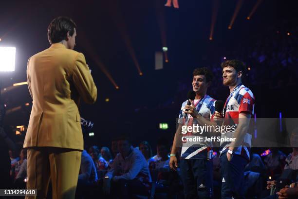 Greg James speaks with Tom Daley and Matty Lee during The National Lottery's Team GB homecoming event at the SSE Arena Wembley on August 15, 2021 in...