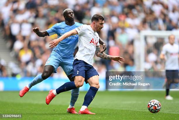 Pierre-Emile Hojbjerg of Tottenham Hotspur is challenged by Benjamin Mendy of Manchester City during the Premier League match between Tottenham...