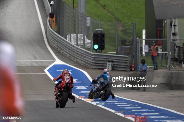 Jack Miller of Australia and Ducati Lenovo Team and Alex Rins of Spain and Team Suzuki ECSTAR restart from box after change the bikes during the...