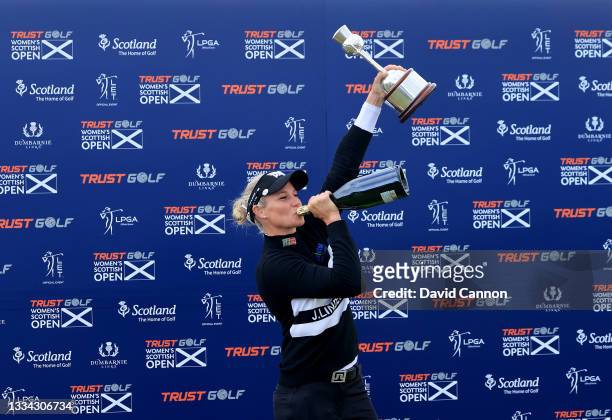 Ryann O'Toole of The United States enjoys a light-hearted moment as she raises a bottle of champagne at the official torphy presentation after her...