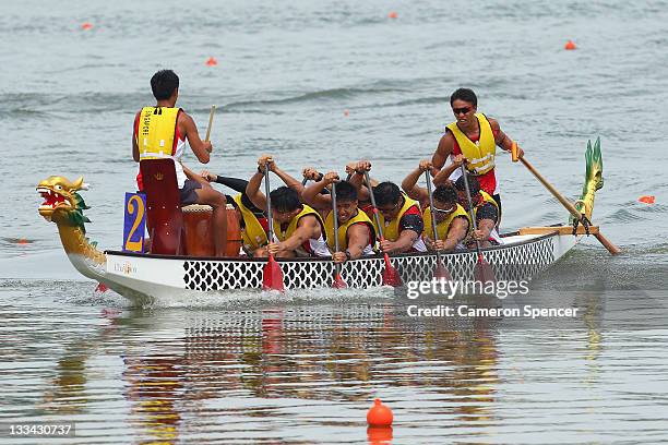 The Singapore Men's 12 crew paddle during traditional boat racing on day nine of the 2011 Southeast Asian Games at Danau Cipule on November 19, 2011...
