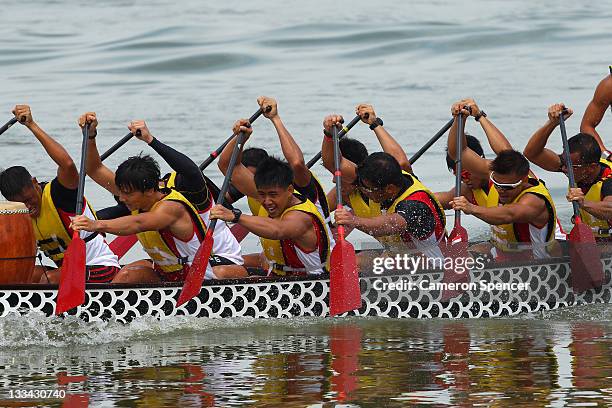 The Singapore Men's 12 crew paddle during traditional boat racing on day nine of the 2011 Southeast Asian Games at Danau Cipule on November 19, 2011...