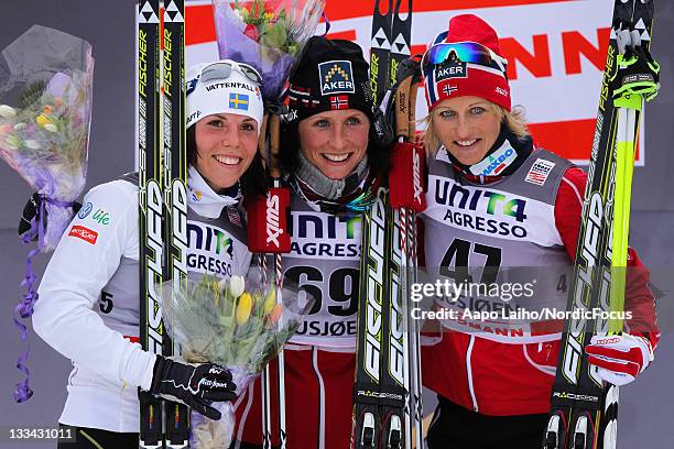 Charlotte Kalla of Sweden, Marit Bjoergen of Norway and Vibeke Skofterud of Norway stand on the podium after the womens individual 10km free technic...