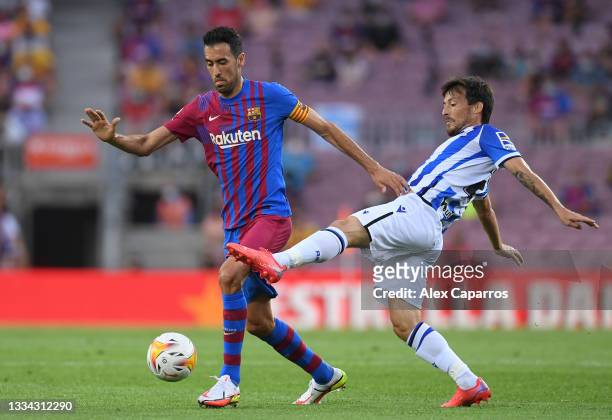 Sergio Busquets of FC Barcelona battles for possession with David Silva of Real Sociedad during the LaLiga Santander match between FC Barcelona and...