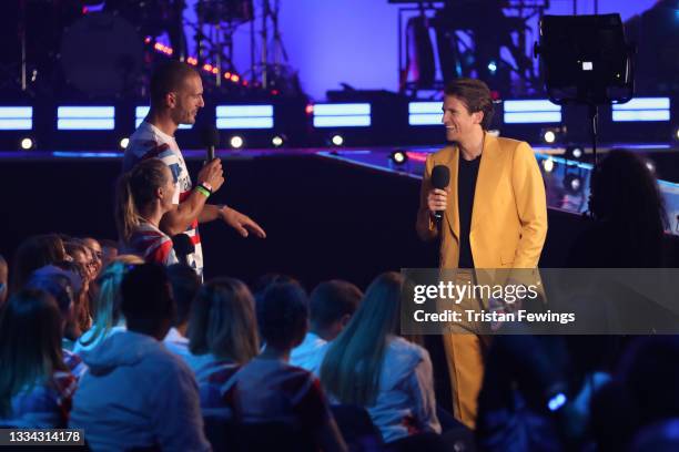 Liam Heath speaks on stage with Greg James during The National Lottery's Team GB homecoming event at the SSE Arena Wembley on August 15, 2021 in...