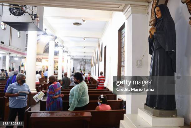 Parishioners prepare to depart Sunday Mass at St. Augustine Catholic Church on August 15, 2021 in New Orleans, Louisiana. Parishioners wore face...