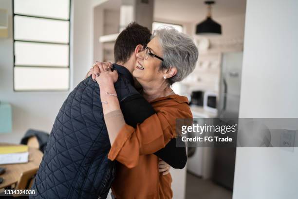 mother and son embracing at home - mother congratulating stock pictures, royalty-free photos & images