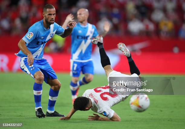 Oussama Idrissi of Sevilla and Mario Suarez of Rayo Vallecano battle for the ball during the La Liga Santader match between Sevilla FC and Rayo...