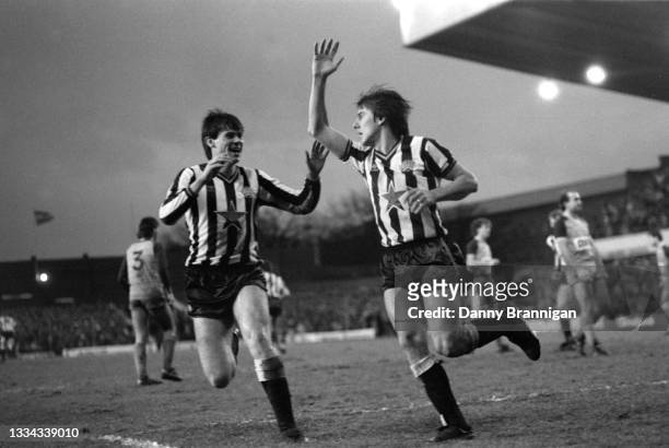 Newcastle striker Peter Beardsley celebrates with Neil McDonald after scoring his hat trick goal during the Division One match between Newcastle...