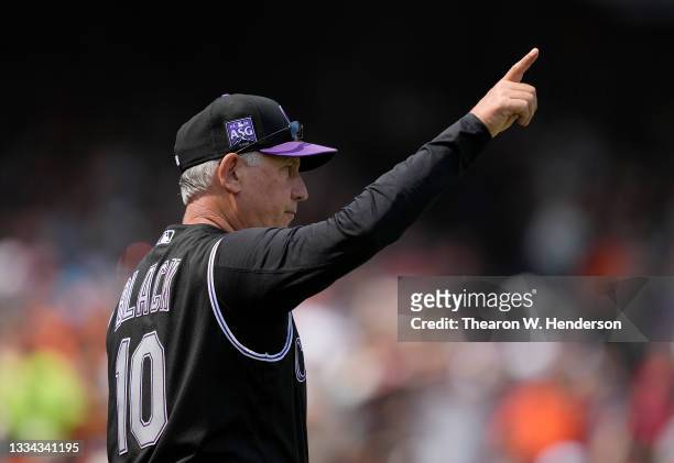 Manager Bud Black of the Colorado Rockies signals the bullpen to make a pitching change against the San Francisco Giants in the bottom of the fifth...