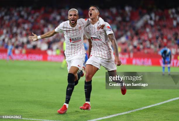 Erik Lamela of Sevilla celebrates with Yousseff En-Nesyri after scoring their team's third goal during the La Liga Santader match between Sevilla FC...