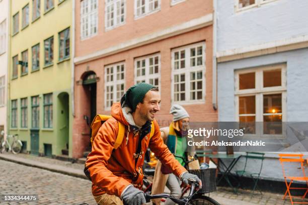 couple enjoying the city ride - copenhagen stock pictures, royalty-free photos & images