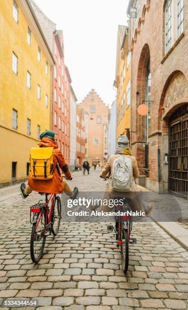 couple enjoying the city ride - copenhagen bicycle stock pictures, royalty-free photos & images