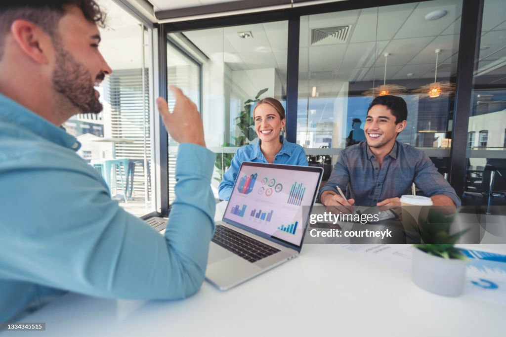 Financial advisor with couple looking through documents.