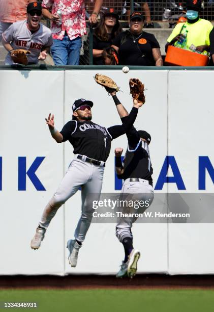 Connor Joe of the Colorado Rockies commits an error on a fly ball off the bat of Kris Bryant of the San Francisco Giants in the bottom of the seventh...