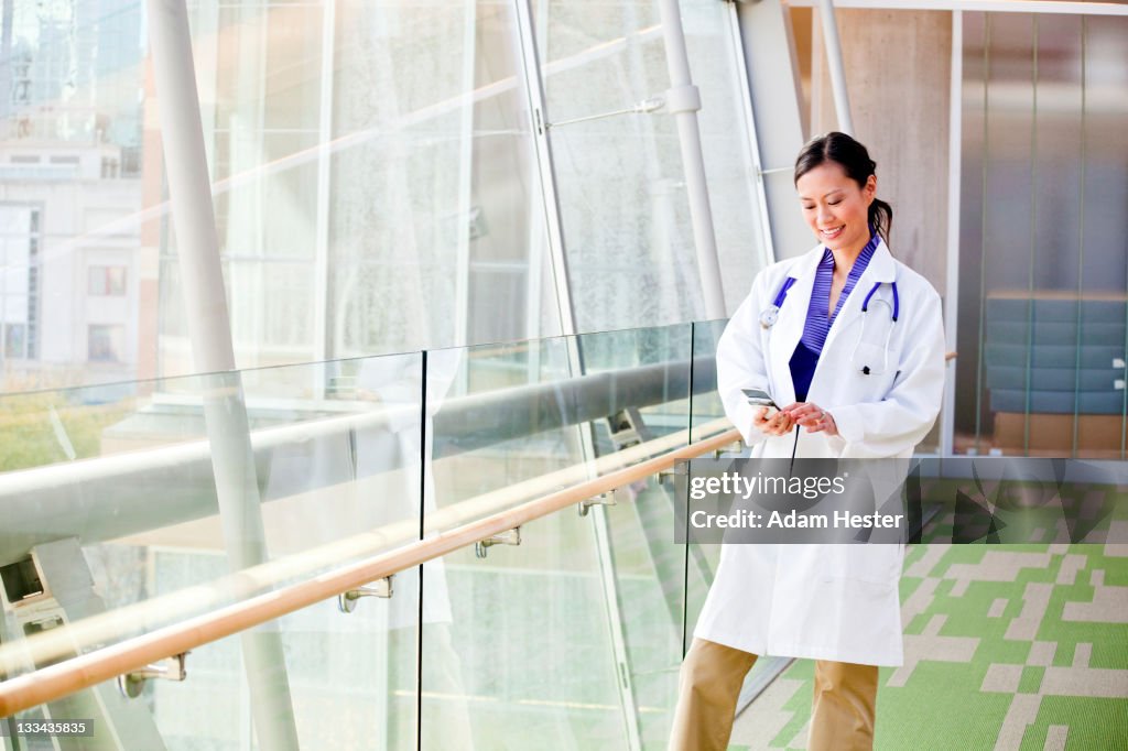 A doctor using a cellular device inside a hospital