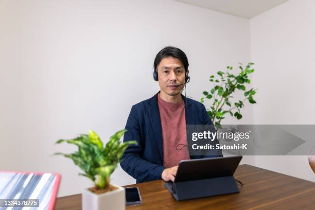 portrait of japanese businessman working from remote location - one mid adult man only stock pictures, royalty-free photos & images