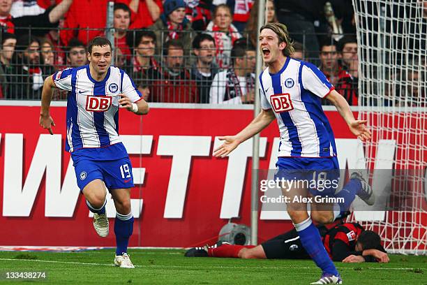 Peter Niemeyer of Berlin celebrates his team's second goal with team mate Pierre-Michel Lasogga during the Bundesliga match between SC Freiburg and...