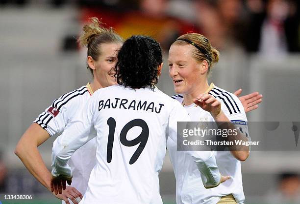 Melanie Behringer celebrates with her team mates Fatmire Bajramaj and Simone Laudehr after scoring her teams nineth goal wit a penalty during the...