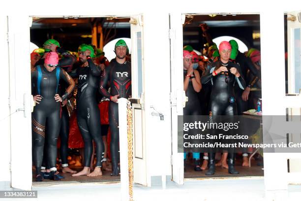 On a boat just off the shore from Alcatraz Island, competitors nervously wait for the start of the 40th annual Escape from Alcatraz Triathlon in San...