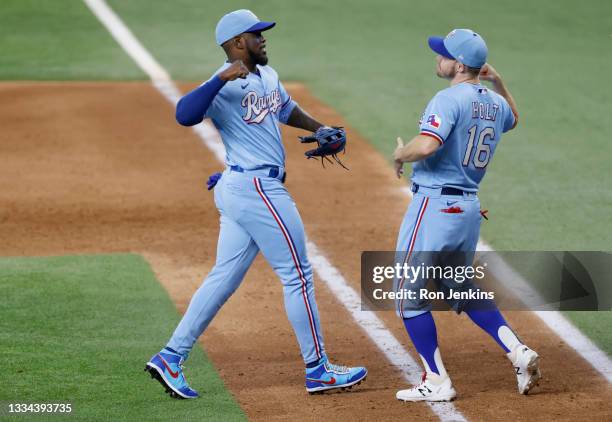 Adolis Garcia of the Texas Rangers and Brock Holt of the Texas Rangers celebrate following the 7-4 win over the Oakland Athletics at Globe Life Field...