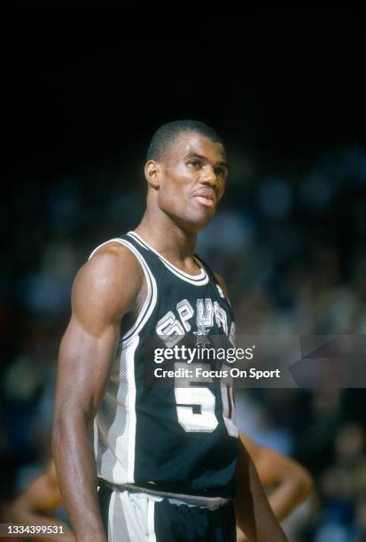 David Robinson of the San Antonio Spurs looks on against the Philadelphia 76ers during an NBA basketball game circa 1989 at The Spectrum in...