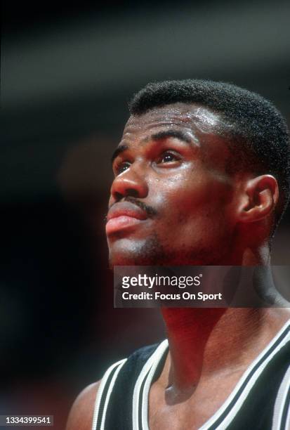 David Robinson of the San Antonio Spurs looks on against the Washington Bullets during an NBA basketball game circa 1994 at the US Airways Arena in...