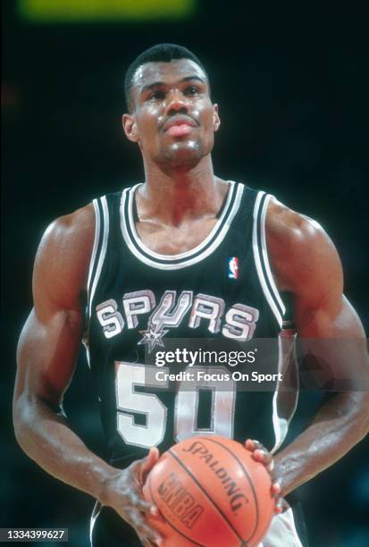 David Robinson of the San Antonio Spurs stands at the line to shoot a foul shot against the Washington Bullets during an NBA basketball game circa...