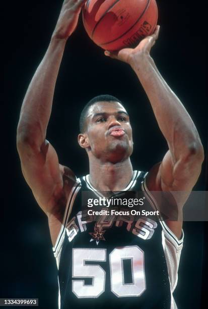 David Robinson of the San Antonio Spurs shoots a foul shot against the Philadelphia 76ers during an NBA basketball game circa 1989 at The Spectrum in...