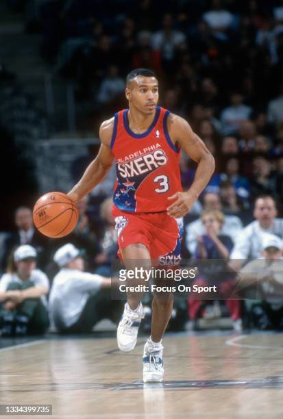 Dana Barros of the Philadelphia 76ers dribbles the ball up court against the Milwaukee Bucks during an NBA basketball game circa 1993 at the Bradley...