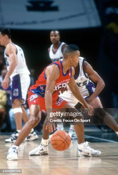 Dana Barros of the Philadelphia 76ers dribbles the ball against the Milwaukee Bucks during an NBA basketball game circa 1993 at the Bradley Center in...