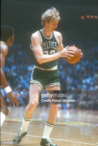 Larry Bird of the Boston Celtics looking to make a move while being defended by Robert Reid of the Houston Rockets during an NBA basketball game...