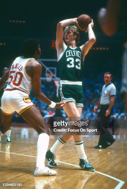 Larry Bird of the Boston Celtics looking to pass while being defended by Robert Reid of the Houston Rockets during an NBA basketball game circa 1981...
