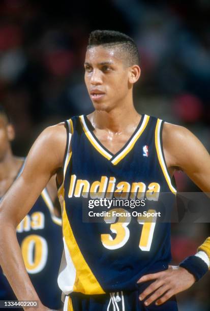 Reggie Miller of the Indiana Pacers looks on against the Chicago Bulls during an NBA basketball game circa 1990 at the Chicago Stadium in Chicago,...