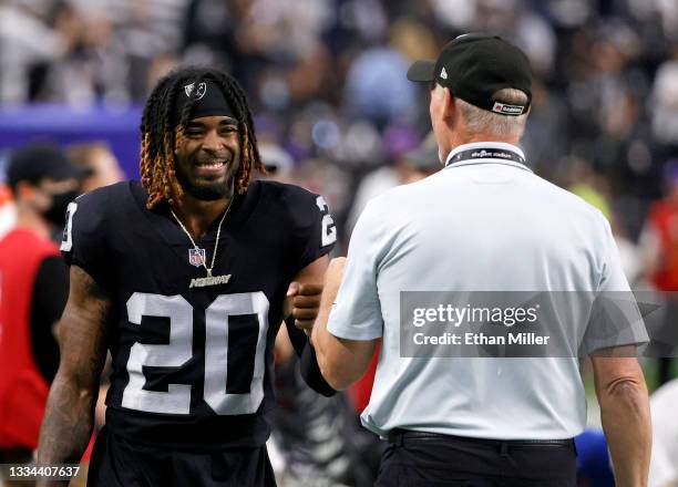 Cornerback Damon Arnette of the Las Vegas Raiders talks with general manager Mike Mayock after the team's 20-7 victory over the Seattle Seahawks in a...