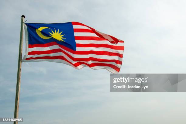 malaysia flag flying - malaysia flag stock pictures, royalty-free photos & images