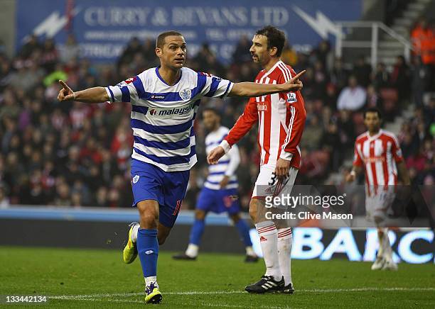 Luke Young of Queens Park Rangers celebrates his goal during the Barclays Premier League match between Stoke City and Queens Park Rangers at...