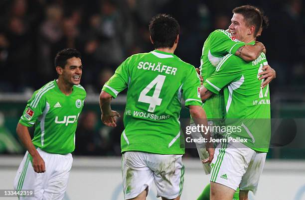 Alexander Madlungn of Wolfsburg celebrates with his team mates after scoring his team's fourth goal during the Bundesliga match between VfL Wolfsburg...