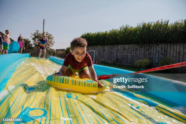 sliding down the slide - water slide stockfoto's en -beelden