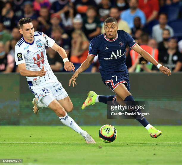 Kylian Mbappe of Paris Saint- Germain goes past Anthony Caci during the Ligue 1 Uber Eats match between Paris Saint Germain and Strasbourg at Parc...