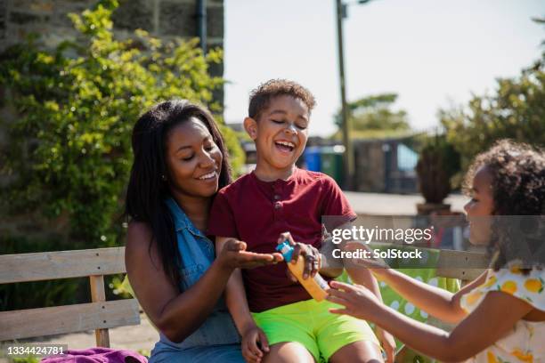 putting on suncream - man spraying stock pictures, royalty-free photos & images