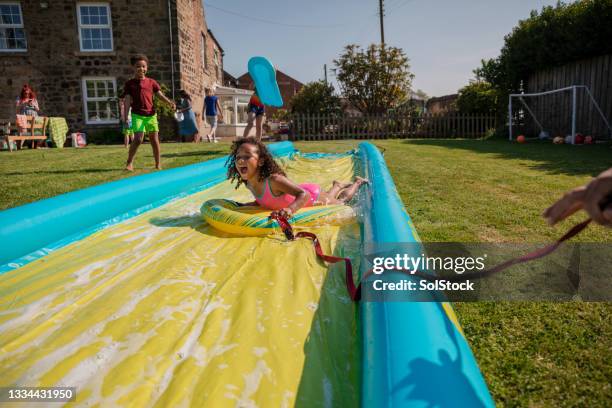 homemade water park - backyard water slide stock pictures, royalty-free photos & images