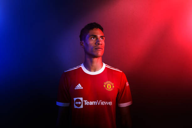 Raphael Varane of Manchester United poses after signing for the club at Carrington Training Ground on August 16, 2021 in Manchester, England.